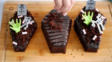 decorating the mini coffin cakes
