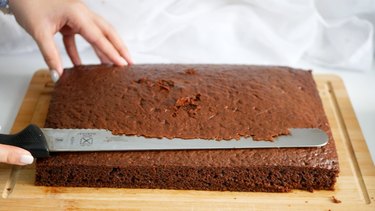 trimming rectangular chocolate cake